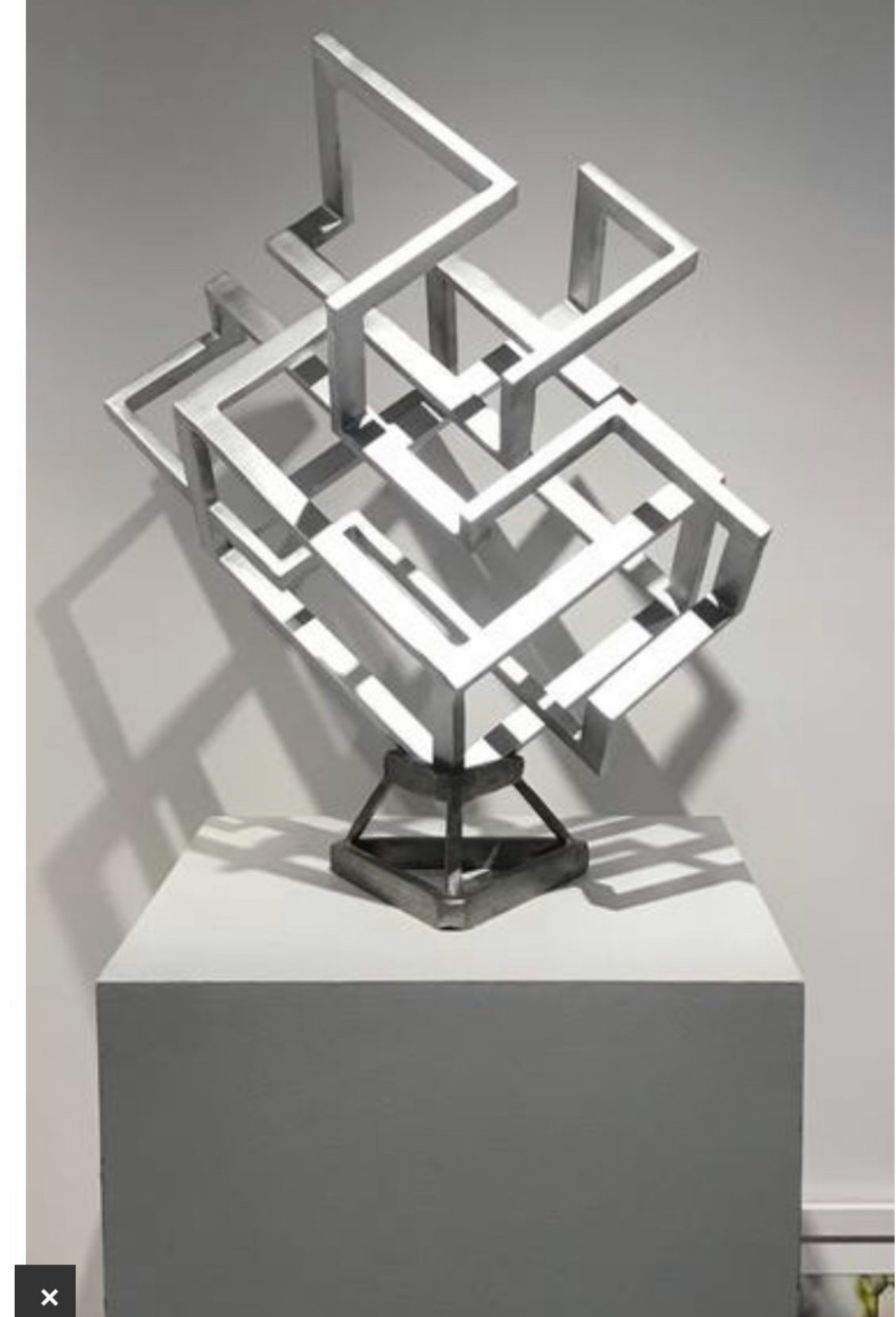 Mirror-polished stainless steel sculpture, interlocking geometric framework
